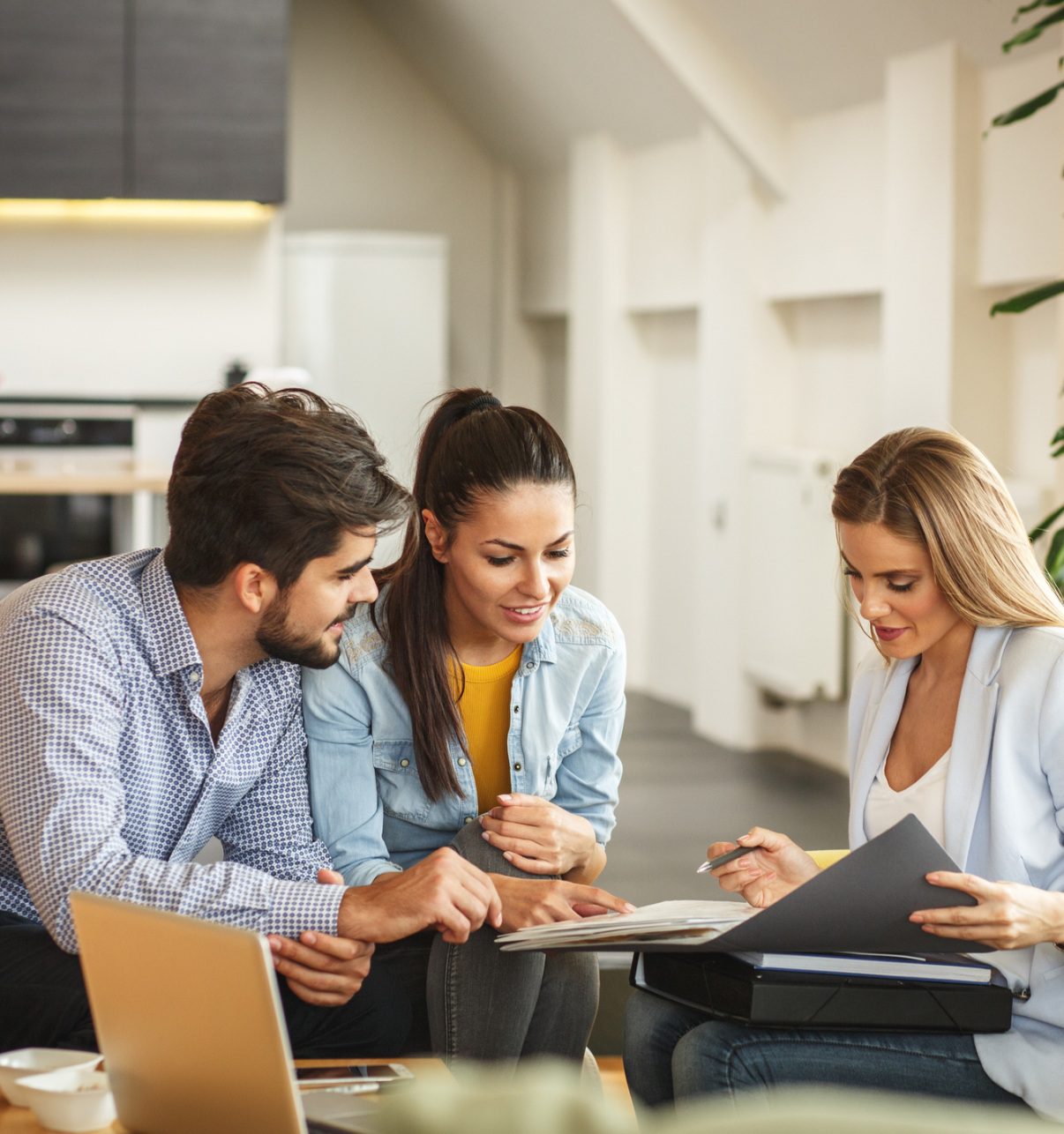 Couple reviewing documents with agent.