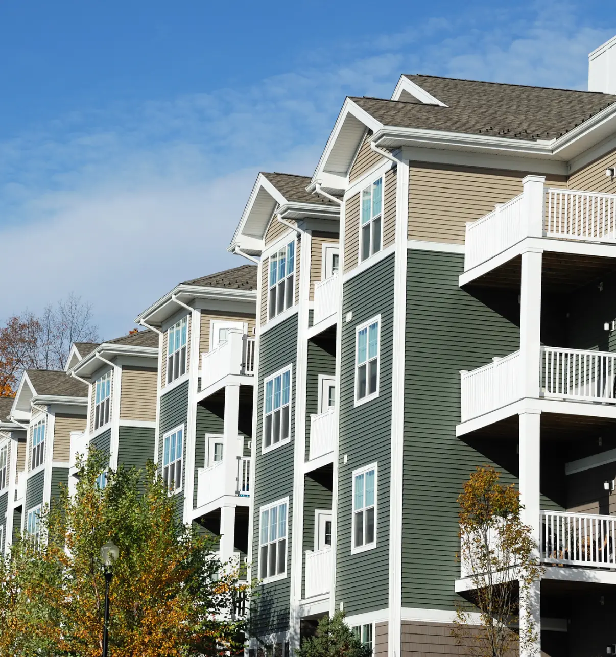 Apartment building exterior, sunny day.